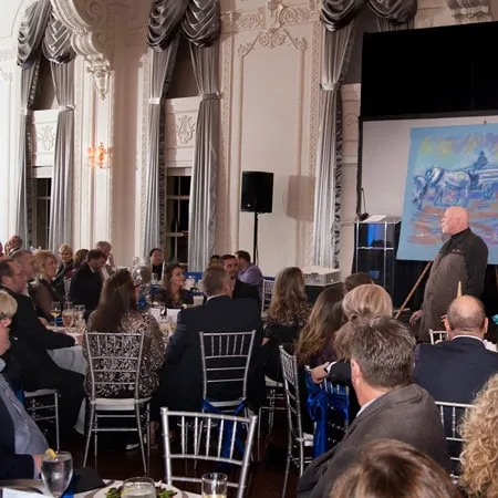 Richard Hight presenting to a banquet hall audience